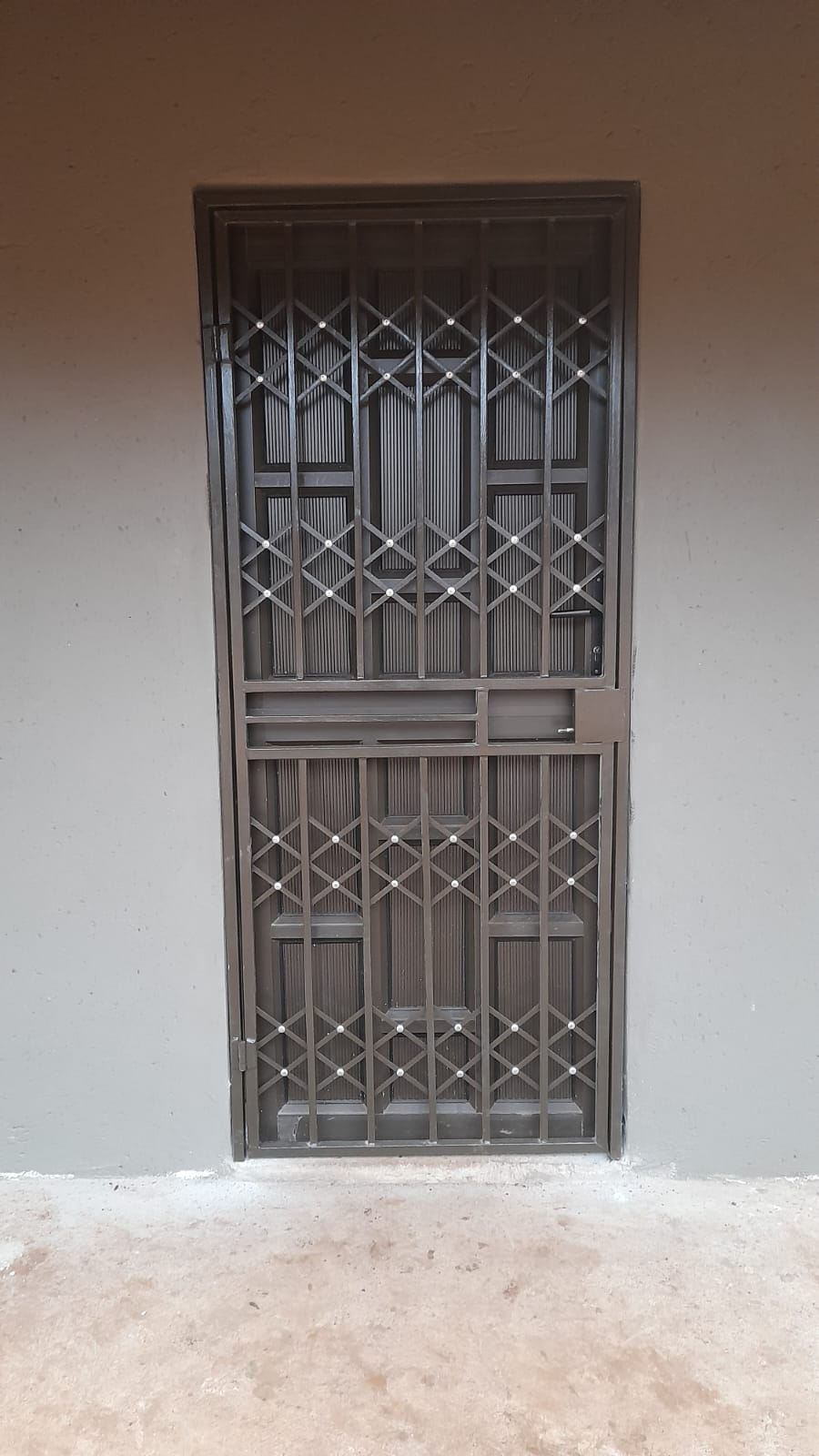 Brown trellis security door installed