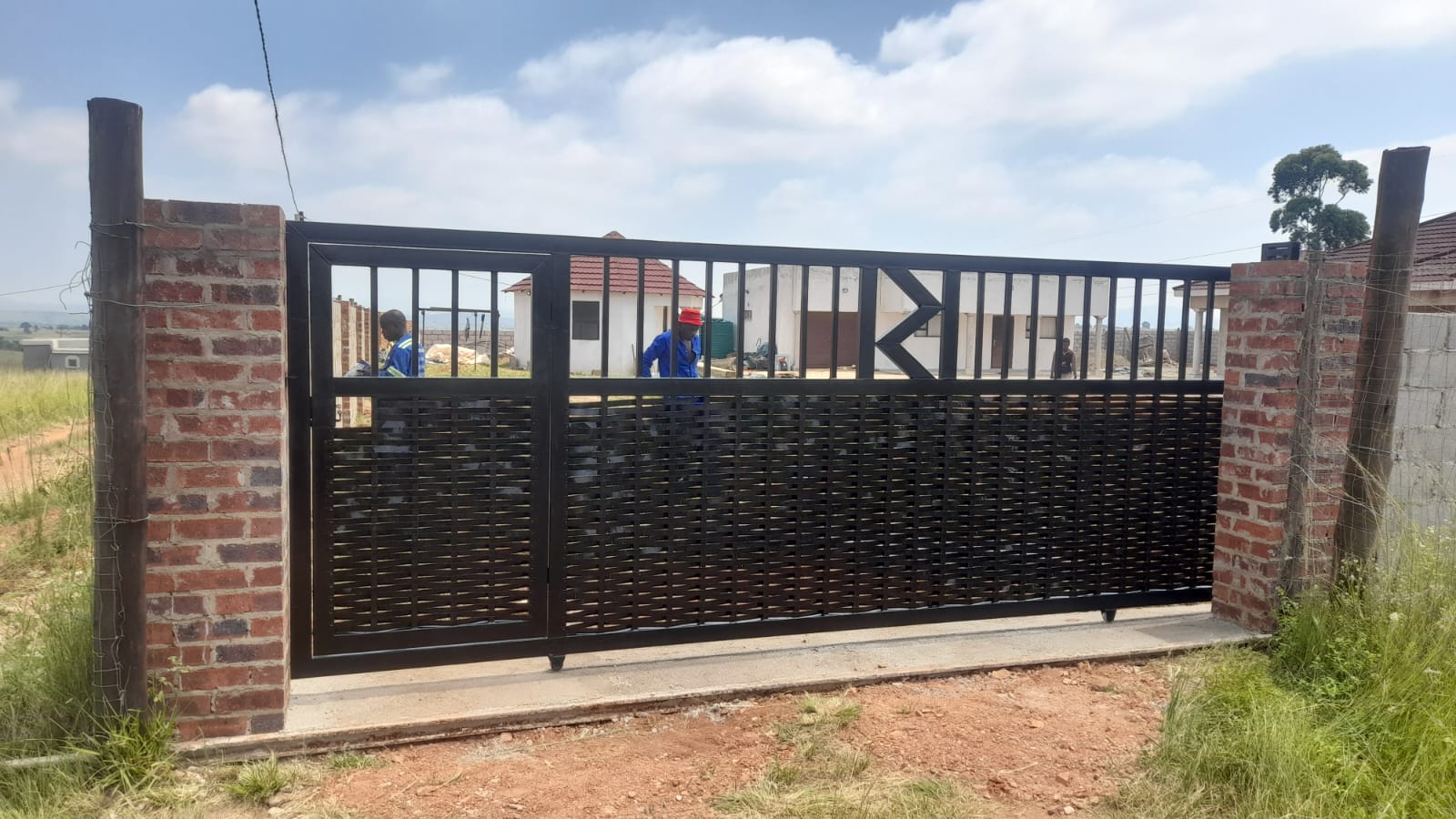 Black grid pattern gate being installed